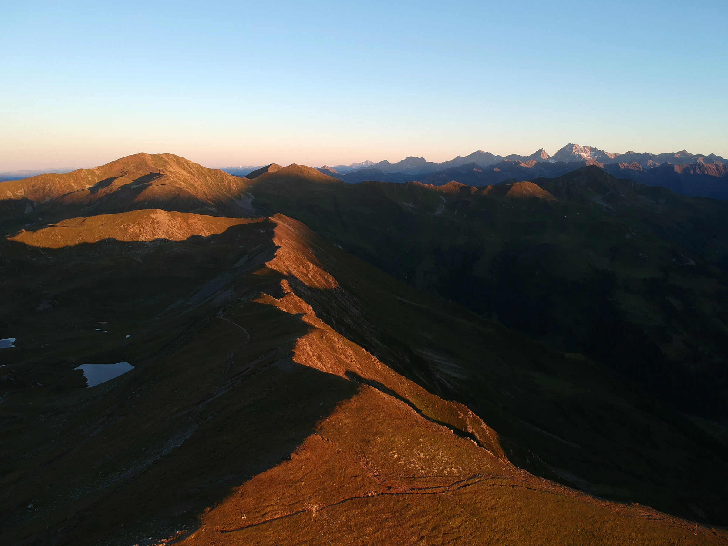 A mountain ridge at dusk, seen from the air.