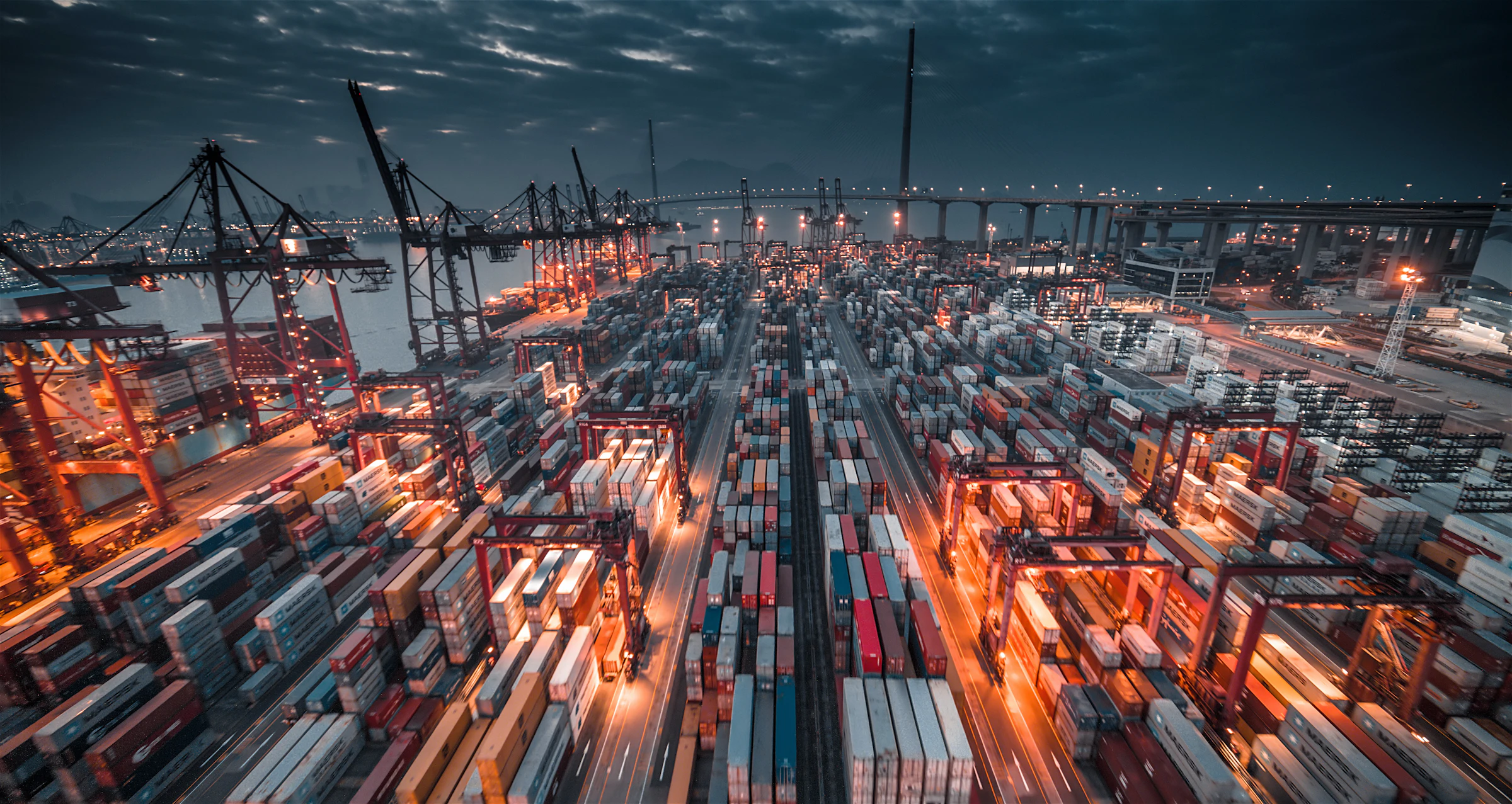 A container port at night, seen from above.