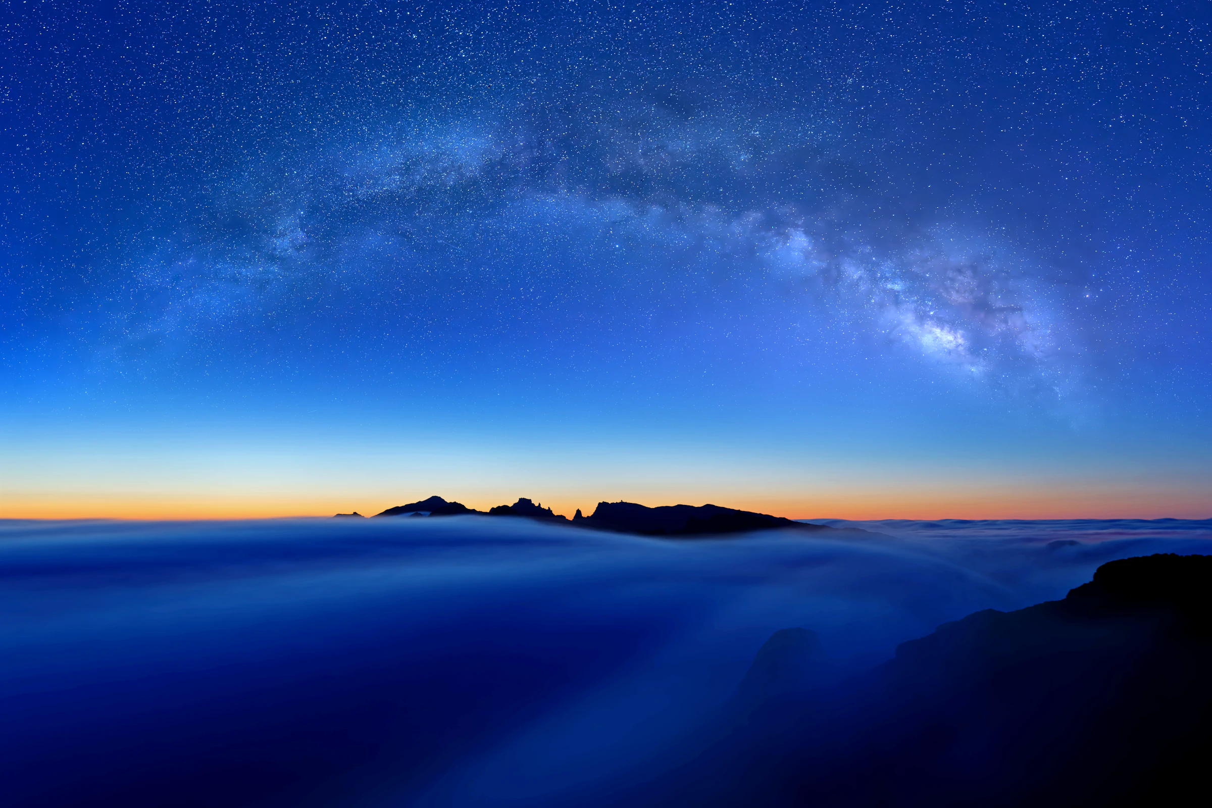 The Milky Way over a sea of cloud at dawn.